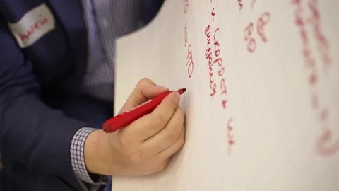 A man writes on a blackboard Stock Footage 177083700