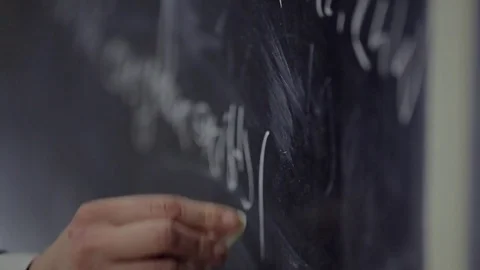 The man writes on the blackboard a mathematical formula Stock Footage 74377342