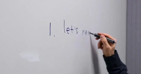 A man writes on the board plans for the day for employees and colleagues 動画素材 274094326
