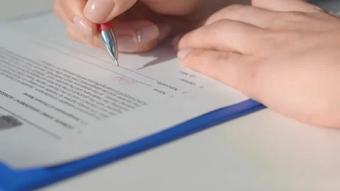 Man writes data in a document with a red pen. Stock Footage 145629560
