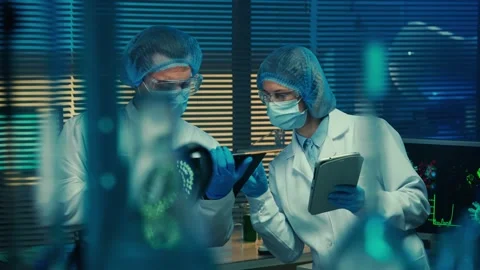A man writes data with a pencil in a folder and a woman checks the information Stock Footage 234295347