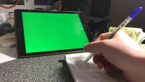 A man writes a to-do list in a notebook. hromakey Stock Footage 103463596