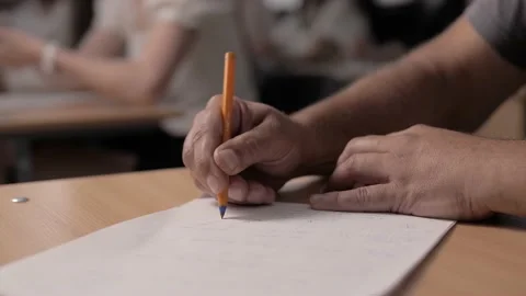 Man writes down a lecture report in his notebook with a ballpoint pen Stock Footage 212404830