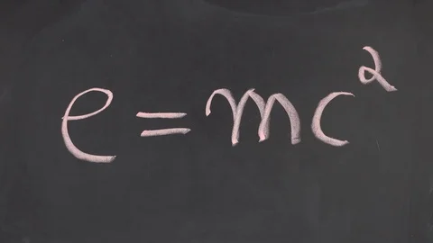 A man writes e equals mc squared on a chalkboard Stock Footage 84037233