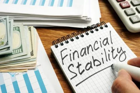 Man writes Financial stability in the note. Stock Photos