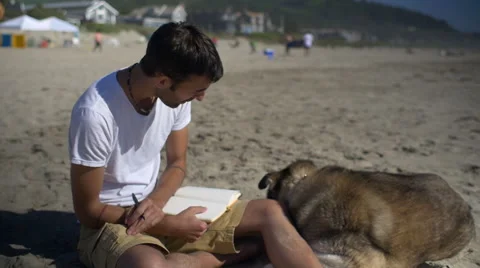 Man writes in his journal Stock Footage 54054058
