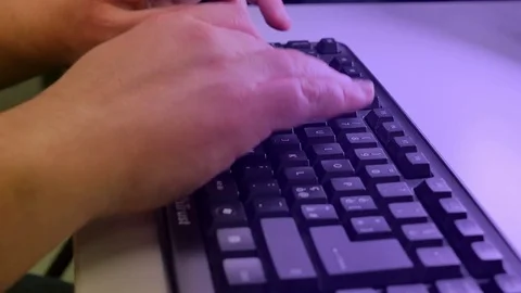 Man writes on the keyboard in front of the screen Stock Footage 85007379