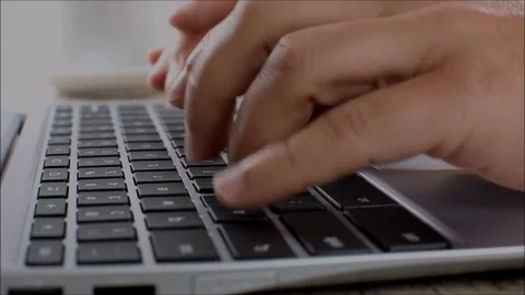 The man writes on a laptop keyboard in the office in close-up Stock Footage 76738515