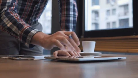 The man writes in a notebook and works on a tablet Stock Footage 86490854