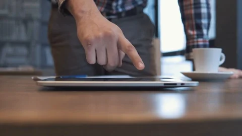 The man writes in a notebook and works on a tablet Stock Footage 86490918