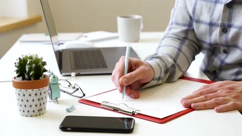 A man writes in a notebook, a business office Stock Footage 149138306