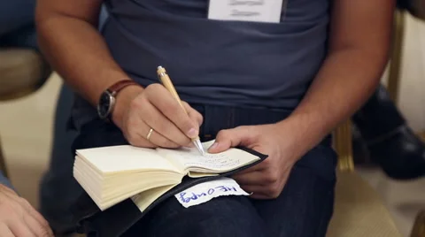 A man writes in a notebook Stock Footage 67354966