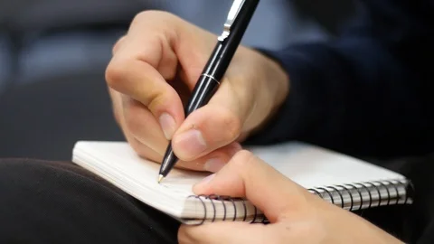 A man writes in a notebook Stock Footage 87311853