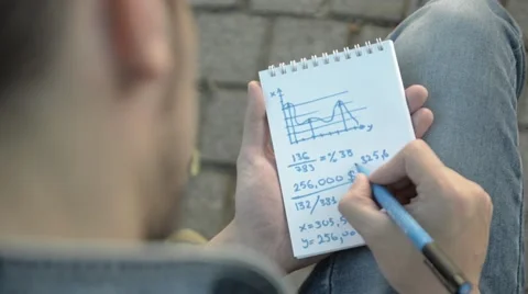 The man writes in a notebook numbers. Stock Footage 51754945