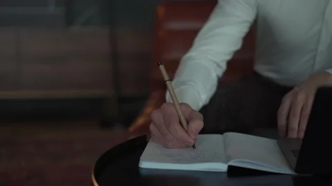 Man writes in a notebook with a pen Stock Footage 168675696
