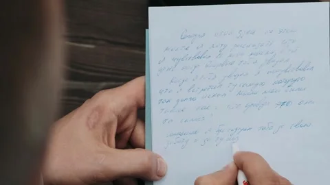 Man writes in a notepad Stock Footage 253541992