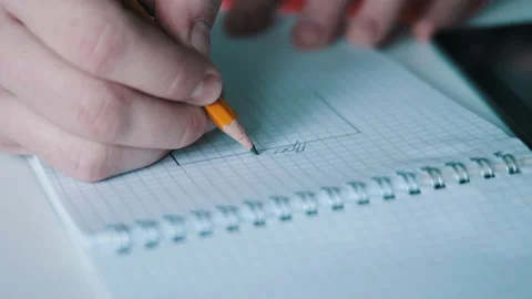 Man writes notes with pencil Stock Footage 142689440