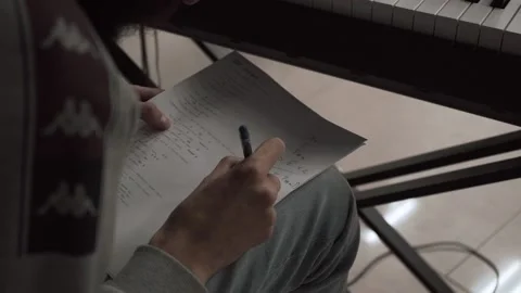 A man writes notes on a piece of paper Stock Footage 131567040