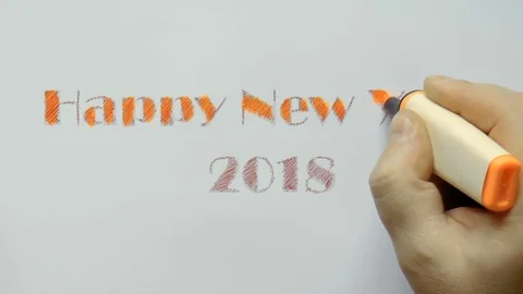 Man writes an orange marker with a happy new year Stock Footage 80856449