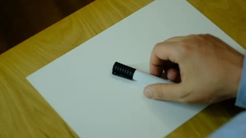 A man writes on paper and draws different UFOs Stockbeeldmateriaal 129720369