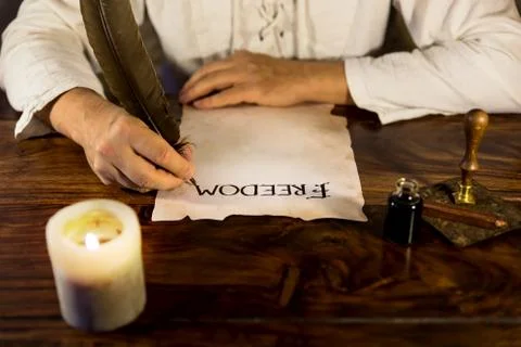 Man writes on parchment freedom 库存照片