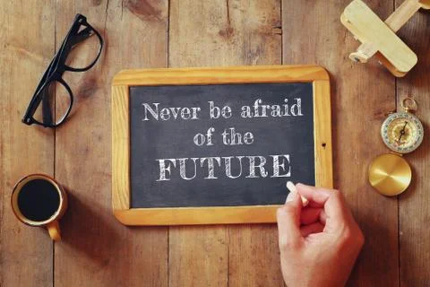 Man writes a phrase: NEVER BE AFRAID OF THE FUTURE Stock Photos