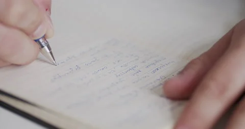 Man writes something down in his diary Stock Footage 150730306