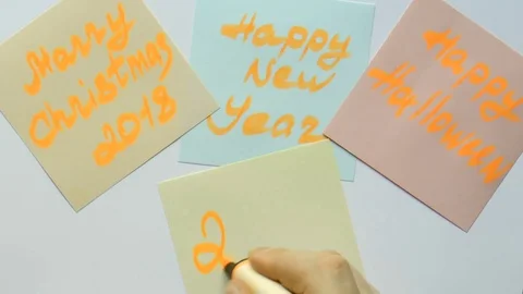 Man writes on a sticker 2018 new year Stock Footage 80856514