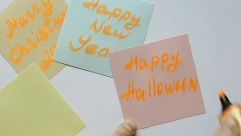 Man writes on a sticker Happy Halloween Stock Footage 80719366