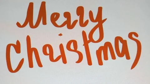 Man writes on a tablet of a marry christmas Stock Footage 80718946