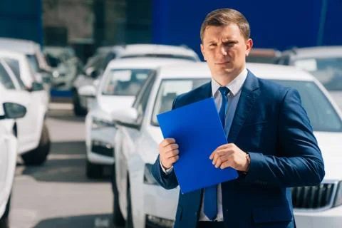 A man writes in a tablet next to the car. An accident on the road, the airbag Stock Photos