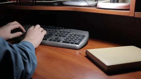 A man writes a text while sitting at a table 動画素材 125091799