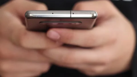 A man writes a texting SMS message using a smartphone. Stock Footage 144751174