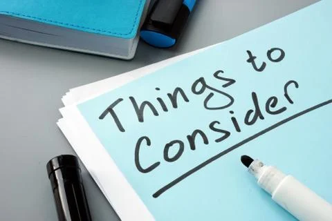 Man writes things to consider list in note. Stock Photos