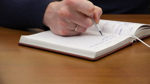 A man writes a white pen Stock Footage 99865596