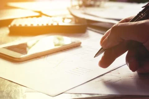 Man writing and make note about cost and expenses at office. Finance concept. Stock Photos