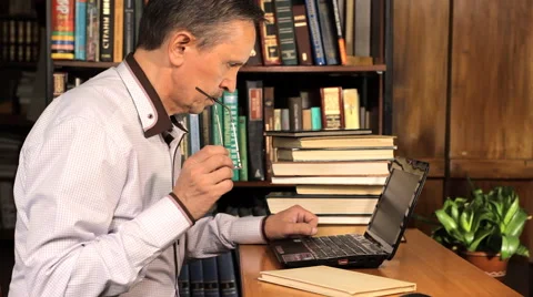 Man writing and studying in the library Video stock 64960262