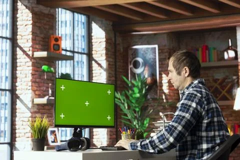 Man writing and testing program code on chroma key PC Stock Photos