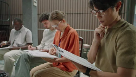 Man Writing Answers during Test on Group Therapy Stock Footage 249669014