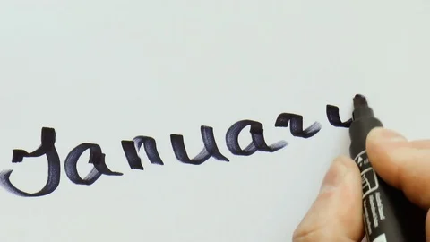 Man is writing a black marker word for January Stock Footage 79850580