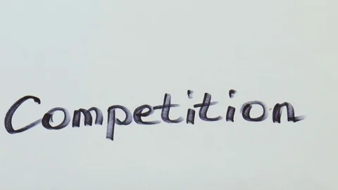 Man is writing a black marker word for competition Stock Footage 79851153