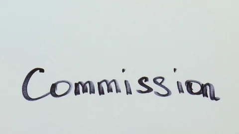 Man is writing a black marker word for commission Stock Footage 79851169
