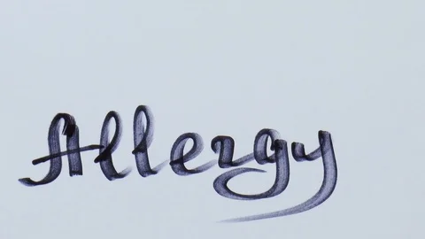 Man is writing a black marker word for allergy Stock Footage 79851253