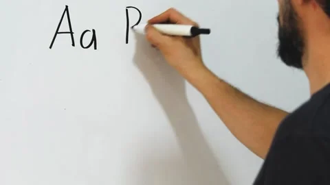 Man writing capital and small letters of the latin alphabet on a whiteboard Stock Footage 340583338