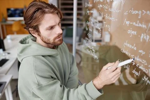 Man Writing Data Code Ideas on Glass in Office Developing New Technology 스톡 사진