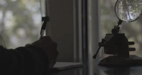 Man Writing On Desk 2 Stock Footage 168780902