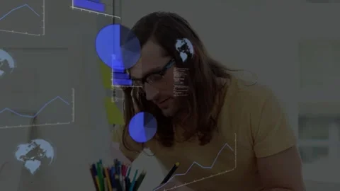 Man writing at desk, causing translucent pie charts line graphs and code Stock Footage 333019480