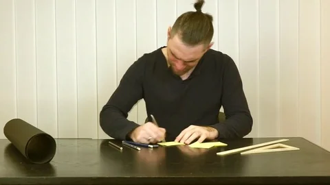 Man writing down and then strike through the text Stock Footage 82562283