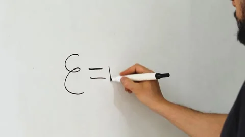 A man writing the famous albert einstein equation E MC on an acrylic whiteboard Vídeo Stock 340583324