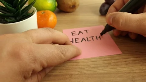 Man writing his dieting plan - eat healthy Stock Footage 240650285